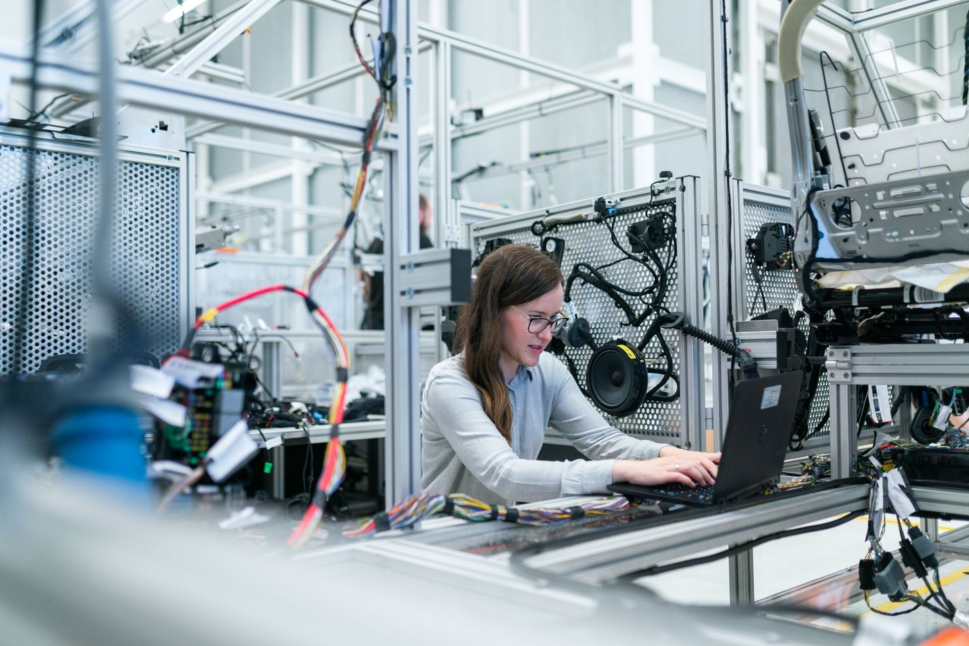 An engineer operating automated production equipment on a factory floor